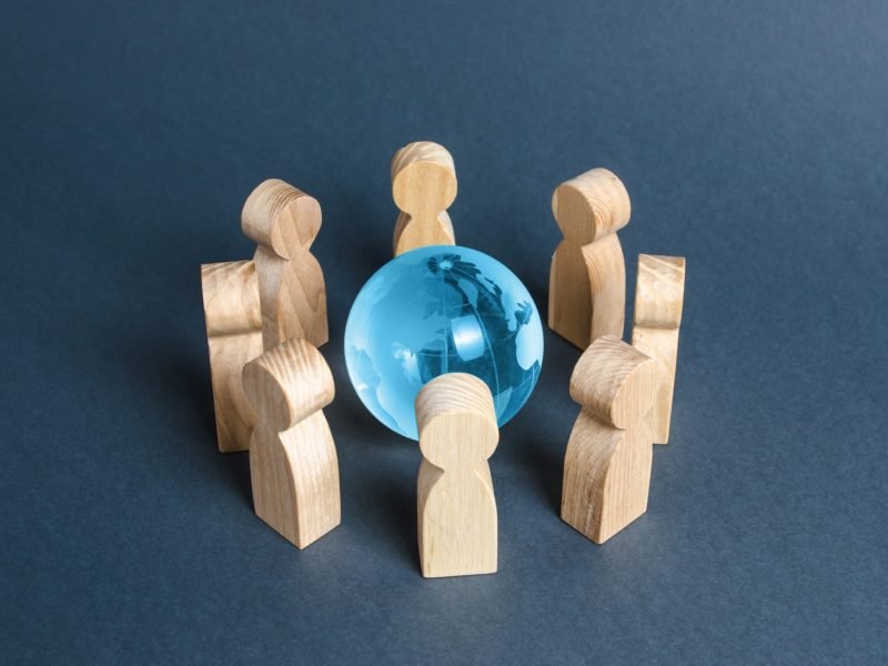 people-surrounded-a-blue-glass-globe-2025-03-18-18-02-07-utc